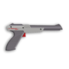 A classic Nintendo Zapper light gun placed next to a vintage NES console and Duck Hunt game cartridge.